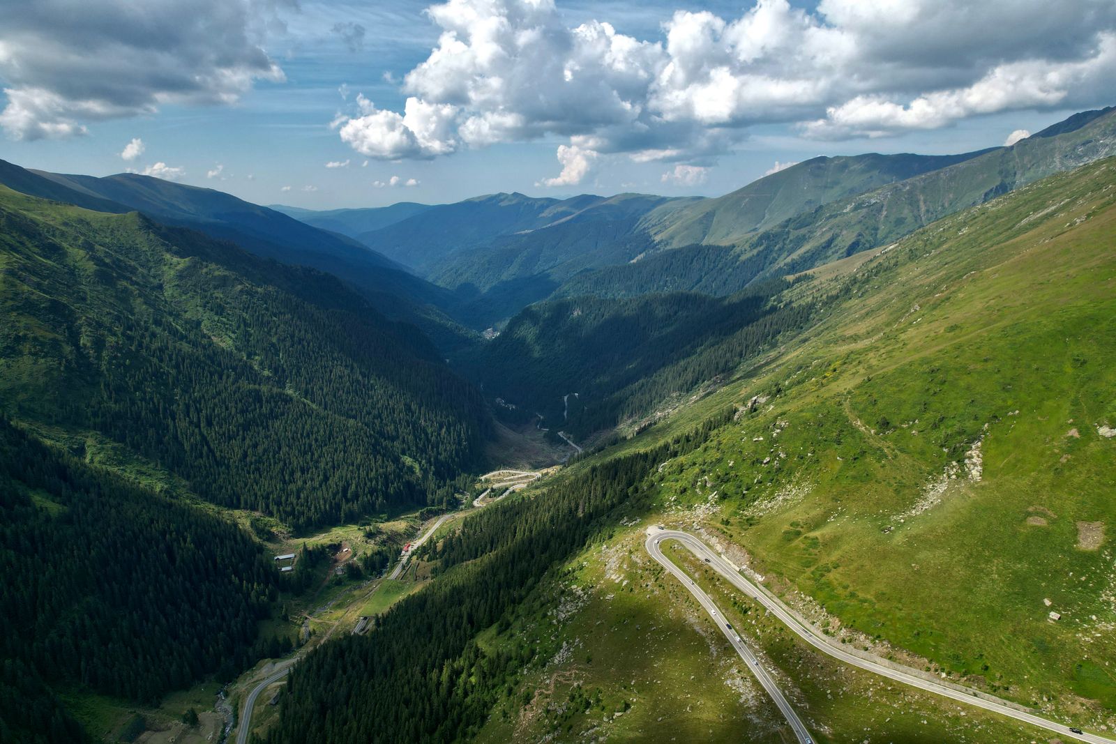 Winding mountain road climbing through the green Tianshan range